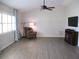 Comfortable living room with vaulted ceiling, ceiling fan, natural light, television, and accent chair at 11536 Sw 138Th Ln, Dunnellon, FL 34432