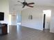 Spacious living room with ceiling fan, view of kitchen, open layout, and modern flooring at 11536 Sw 138Th Ln, Dunnellon, FL 34432