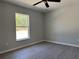 Spacious bedroom with vinyl flooring, ceiling fan, and a window offering natural light at 1233 Sw Winding Hills Rd, Dunnellon, FL 34431