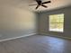 Bright bedroom featuring vinyl flooring, ceiling fan, and a window for natural lighting at 1233 Sw Winding Hills Rd, Dunnellon, FL 34431