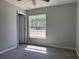 Bright bedroom with large window allowing natural light, ceiling fan, and vinyl flooring at 1233 Sw Winding Hills Rd, Dunnellon, FL 34431