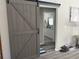 A sliding barn door entrance to a bathroom at 13356 Sw 66Th St, Ocala, FL 34481