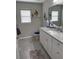 Bathroom featuring a white vanity with granite countertops, a sink, and decorative fish on the wall at 13356 Sw 66Th St, Ocala, FL 34481