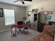 Cozy bedroom with a ceiling fan, large window with blinds, and a fun pink desk and chair at 13356 Sw 66Th St, Ocala, FL 34481