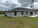 Exterior view of the home showing the back of the property with patio and installed propane tank at 13356 Sw 66Th St, Ocala, FL 34481