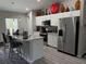 Modern kitchen featuring stainless steel appliances, granite countertops, and a spacious island at 13356 Sw 66Th St, Ocala, FL 34481
