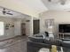 Comfortable living room featuring a gray couch, front door, and sliding barn door, with wood-look floors at 13356 Sw 66Th St, Ocala, FL 34481