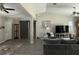 Comfortable living room featuring a gray couch, front door, and sliding barn door, with wood-look floors at 13356 Sw 66Th St, Ocala, FL 34481