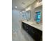 Bathroom with dual sinks, quartz countertops, and tiled walk-in shower at 13506 Sw 114Th Ln, Dunnellon, FL 34432