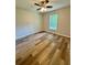 Small bedroom featuring a ceiling fan, one window and wood-look floors at 13506 Sw 114Th Ln, Dunnellon, FL 34432