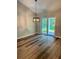 Dining area with modern pendant lighting and sliding glass doors to outdoors at 13506 Sw 114Th Ln, Dunnellon, FL 34432