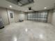 Spacious garage with an epoxy floor, an insulated garage door, and overhead lighting at 13506 Sw 114Th Ln, Dunnellon, FL 34432