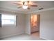 Cozy bedroom with ceiling fan, a view into the bathroom, and ample natural light through windows at 13675 Sw 111Th Ave, Dunnellon, FL 34432