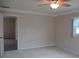 Bedroom with carpet, neutral walls, and view into an adjacent room perfect for flexible living at 13675 Sw 111Th Ave, Dunnellon, FL 34432
