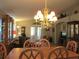 Charming dining area with chandelier overlooks the comfortable living room at 13675 Sw 111Th Ave, Dunnellon, FL 34432