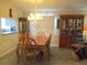 Charming dining room with chandelier adjacent to kitchen and china cabinet at 13675 Sw 111Th Ave, Dunnellon, FL 34432
