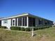 Single-story house with a screened-in porch and well-kept landscaping at 13675 Sw 111Th Ave, Dunnellon, FL 34432
