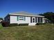 Well-maintained single-story home with a manicured lawn and a screened-in porch at 13675 Sw 111Th Ave, Dunnellon, FL 34432