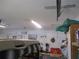 Clean garage featuring a work bench, peg board, storage shelf and an overhead hoist for additional storage at 13675 Sw 111Th Ave, Dunnellon, FL 34432