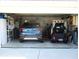 Neat and organized garage featuring a golf cart and a car, with storage shelves and cabinets visible at 13675 Sw 111Th Ave, Dunnellon, FL 34432