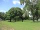 Lush green area with mature trees draped in Spanish moss, offering a serene and picturesque view at 13675 Sw 111Th Ave, Dunnellon, FL 34432