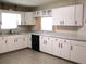 Well-lit kitchen with white cabinets and gray countertops, ready for cooking at 13675 Sw 111Th Ave, Dunnellon, FL 34432