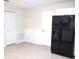 Bright kitchen area with a modern black refrigerator and door to the living area at 13675 Sw 111Th Ave, Dunnellon, FL 34432