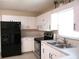 Updated kitchen featuring a modern refrigerator and stainless-steel appliances at 13675 Sw 111Th Ave, Dunnellon, FL 34432