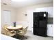 Bright eat-in kitchen showcasing modern appliances and a cozy dining area with comfortable chairs at 13675 Sw 111Th Ave, Dunnellon, FL 34432