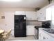 Clean kitchen featuring modern appliances, white cabinets, and a convenient dining area at 13675 Sw 111Th Ave, Dunnellon, FL 34432