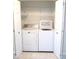 Convenient laundry closet with washer and dryer; includes shelving for organized storage at 13675 Sw 111Th Ave, Dunnellon, FL 34432