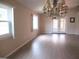 Inviting living room featuring a stylish chandelier, wood floors, and sliding doors leading to outdoor space at 13675 Sw 111Th Ave, Dunnellon, FL 34432