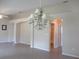 Bright living room with an elegant chandelier and neutral walls creating a warm, inviting atmosphere at 13675 Sw 111Th Ave, Dunnellon, FL 34432