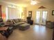 Comfortable living room features a neutral color palette, tile floors and access to a screened porch at 13675 Sw 111Th Ave, Dunnellon, FL 34432