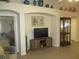 Living room with a wall niche, decor, modern television, and stylish cabinets at 13675 Sw 111Th Ave, Dunnellon, FL 34432