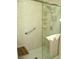 Modern shower with glass door, bench, grab bar, and handheld shower head at 13675 Sw 111Th Ave, Dunnellon, FL 34432