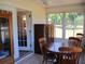 Sun room featuring tile floors, wood furniture, and several windows at 13675 Sw 111Th Ave, Dunnellon, FL 34432