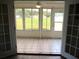 Bright sunroom with tiled floor offering panoramic views of the green backyard at 13675 Sw 111Th Ave, Dunnellon, FL 34432
