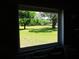 Scenic view from a window overlooking a lush, green lawn and mature trees at 13675 Sw 111Th Ave, Dunnellon, FL 34432