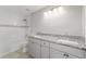 Bathroom showcasing double sinks with granite countertops, white cabinets, tile flooring, and bathtub/shower combo at 14085 Sw 34Th Terrace Rd, Ocala, FL 34473