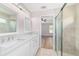 Bright and airy bathroom featuring a double vanity, large mirrors, and a glass shower with tile surround at 14085 Sw 34Th Terrace Rd, Ocala, FL 34473