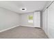 Bedroom features neutral gray walls, carpet, modern ceiling fan, closet and window with built-in closet at 14085 Sw 34Th Terrace Rd, Ocala, FL 34473