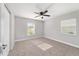 Cozy bedroom with carpeting, a ceiling fan, and two windows providing natural light at 14085 Sw 34Th Terrace Rd, Ocala, FL 34473