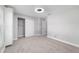 Bedroom features neutral gray walls, carpet, modern ceiling fan, closet and window with built-in closet at 14085 Sw 34Th Terrace Rd, Ocala, FL 34473