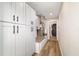Hallway with white cabinets, butcher block countertop and wood-look flooring, with a view into the laundry room at 14085 Sw 34Th Terrace Rd, Ocala, FL 34473