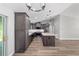 Bright, modern kitchen with gray cabinets, stainless steel appliances and a large island with marble countertop at 14085 Sw 34Th Terrace Rd, Ocala, FL 34473