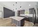 Modern kitchen featuring a center island, gray cabinets, stainless steel appliances, and updated flooring at 14085 Sw 34Th Terrace Rd, Ocala, FL 34473