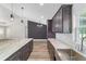 Gourmet kitchen featuring gray cabinets, marble countertops, updated stainless appliances and a center island with sink at 14085 Sw 34Th Terrace Rd, Ocala, FL 34473
