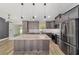 The kitchen is updated with gray cabinets, stainless steel appliances, and an island with seating at 14085 Sw 34Th Terrace Rd, Ocala, FL 34473