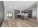 Modern kitchen boasts gray cabinets, stainless steel appliances, and a center island with marble countertop at 14085 Sw 34Th Terrace Rd, Ocala, FL 34473